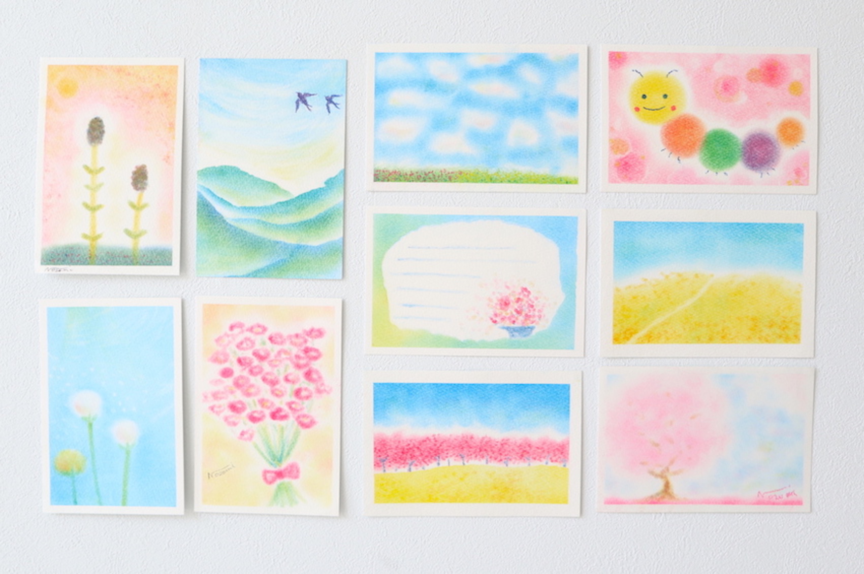 パステルで描いた春の作品集の写真です。つくし、ツバメ、花畑、花束、菜の花、桜並木、タンポポなど。
